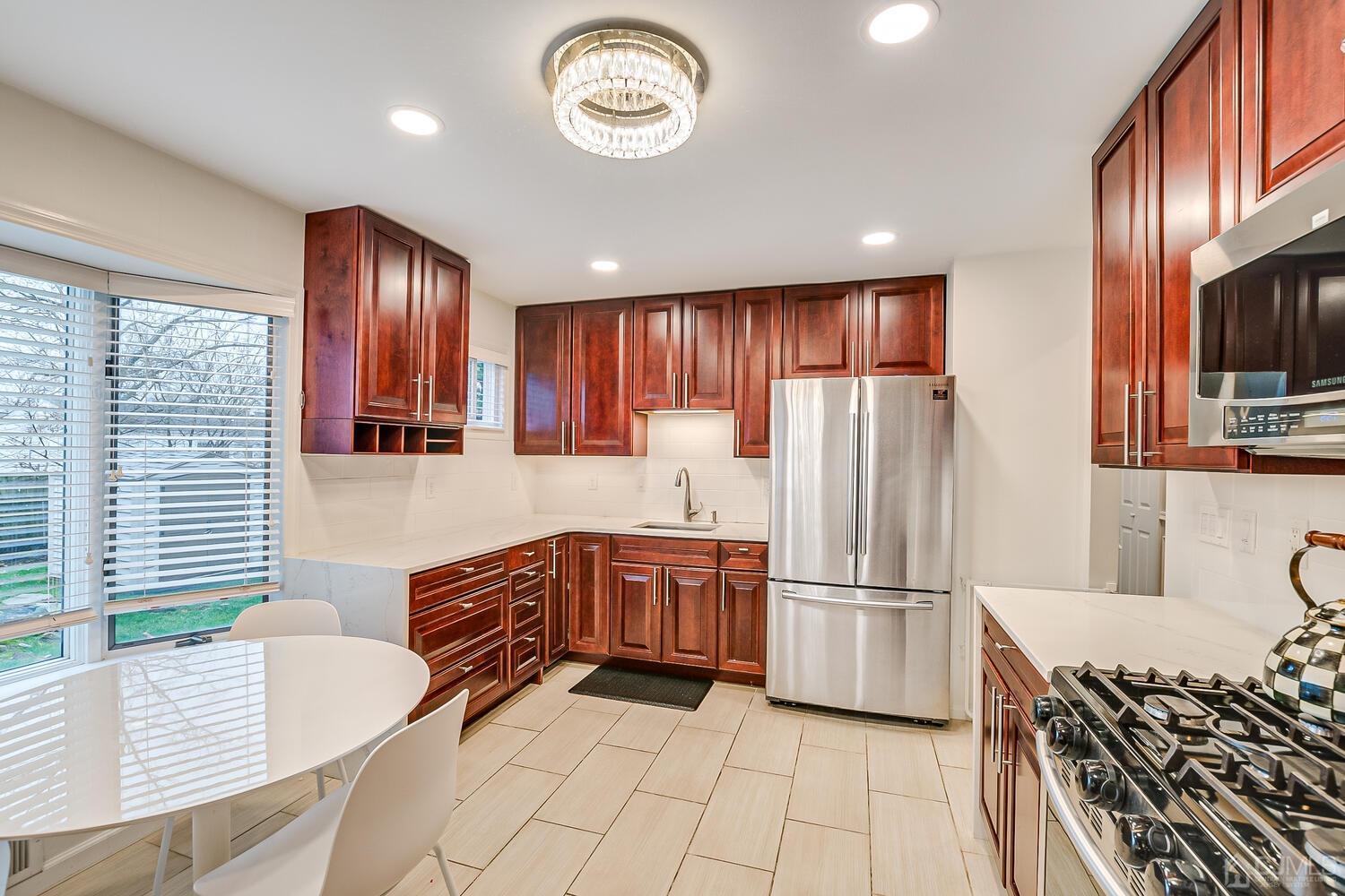 12 Eardley Road Edison, NJ 08817 - Photo 17 of 36 a kitchen with stainless steel appliances granite countertop a refrigerator and a stove top oven