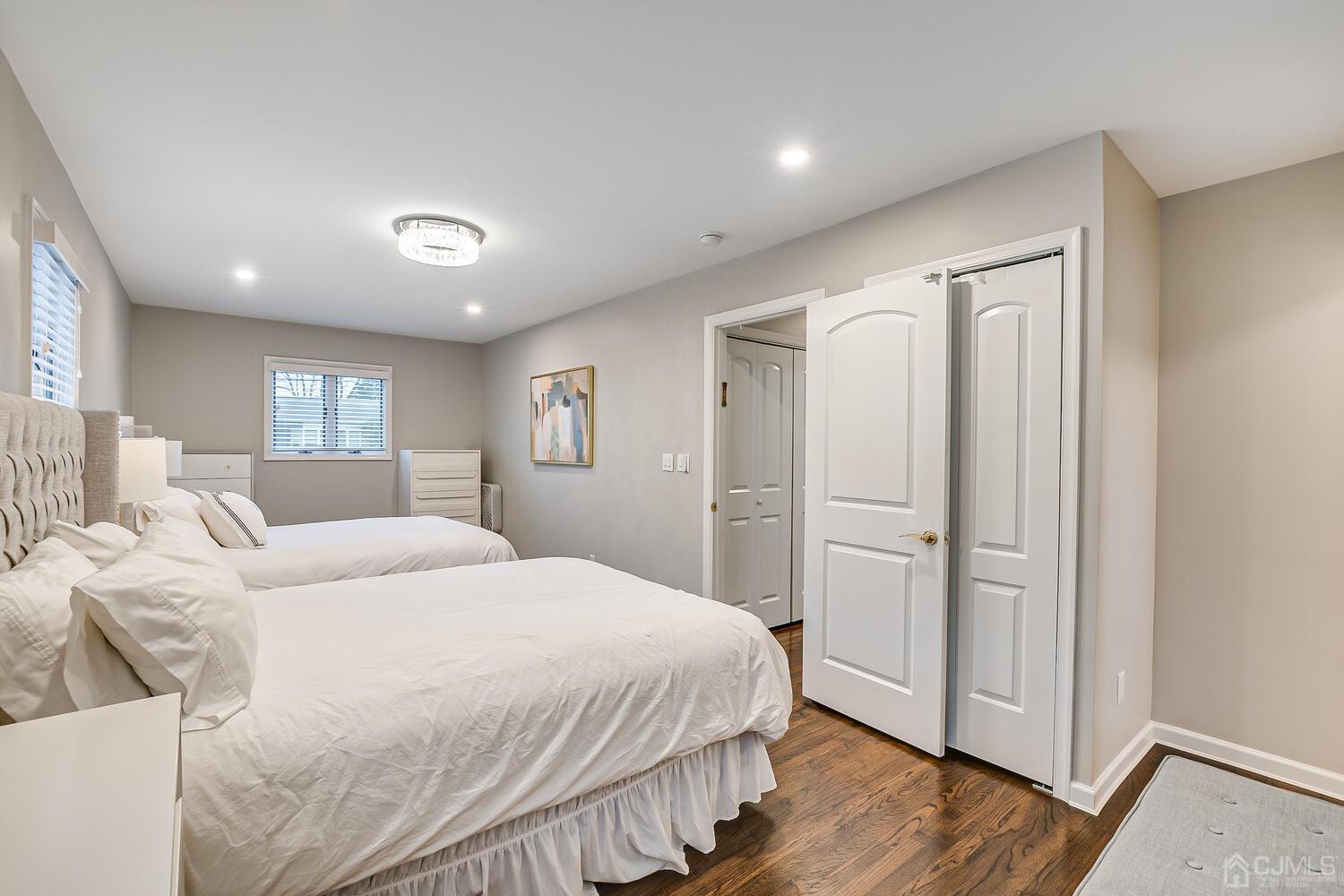 12 Eardley Road Edison, NJ 08817 - Photo 19 of 36 a spacious bedroom with a bed and a wooden floor