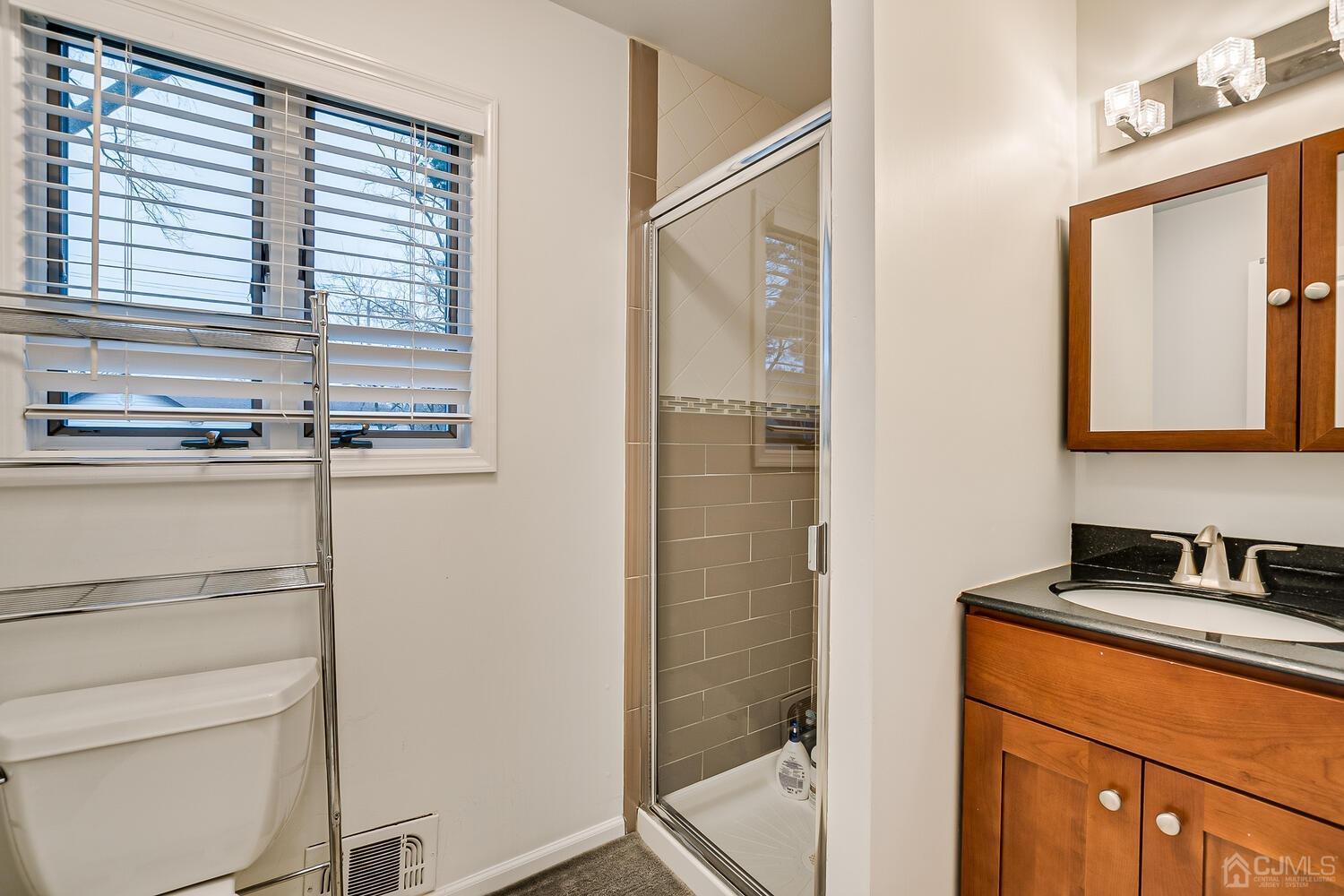 12 Eardley Road Edison, NJ 08817 - Photo 21 of 36 a bathroom with a sink and a mirror