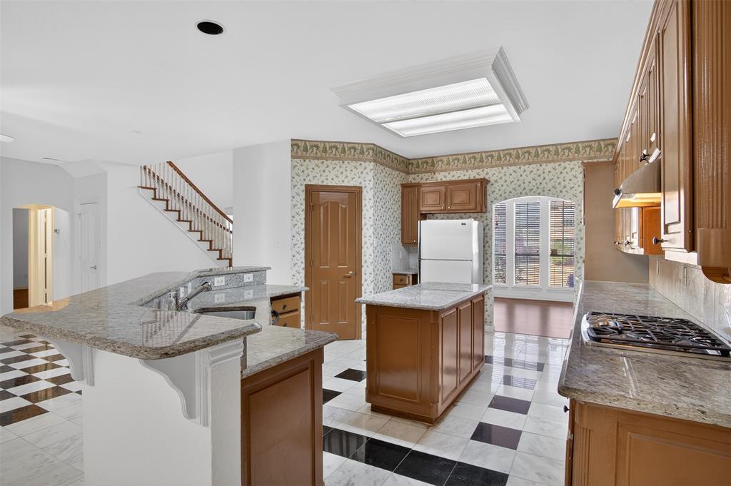 3716 Lowrey Way Plano, TX 75025 - Photo 8 of 28 a kitchen with granite countertop a sink stove and cabinets