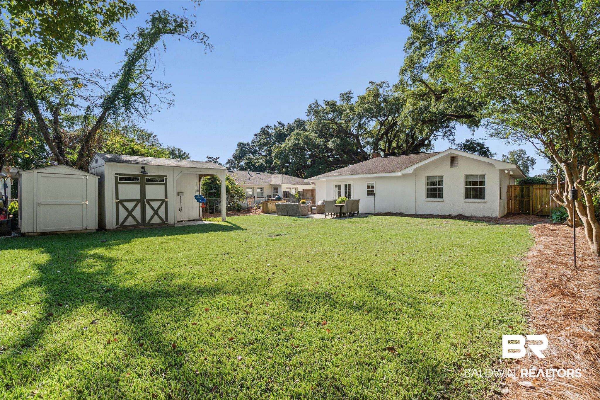 4310 The Cedars Avenue Mobile, AL 36608 - Photo 26 of 32 Fenced backyard featuring a shed and a patio