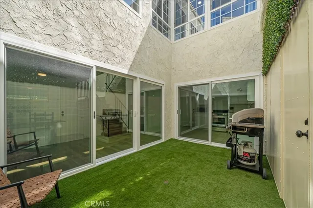 a kitchen with white cabinets stainless steel appliances and a sink