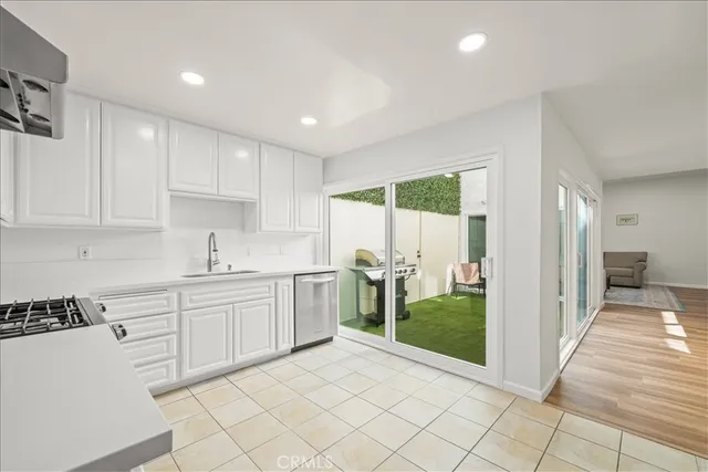 a spacious bedroom with a bed and wooden floor