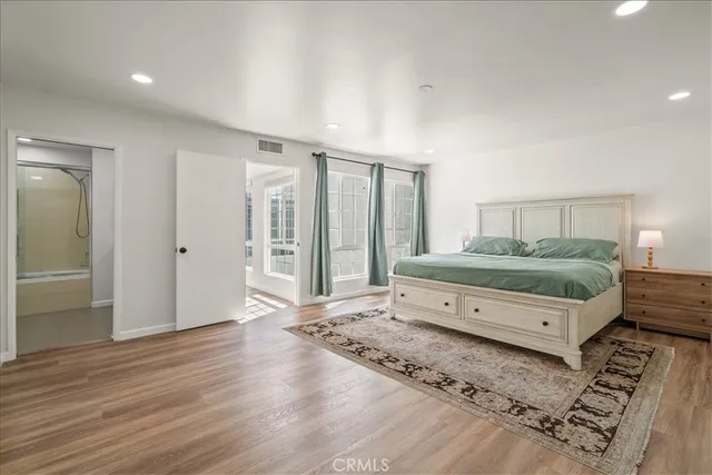 a spacious bedroom with a large bed and a large window