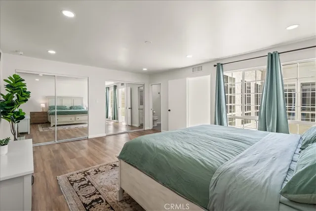 a living room with a bed and a flat screen tv