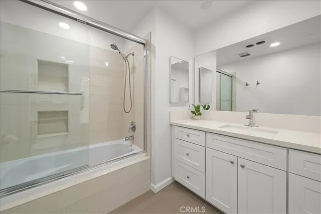 a bathroom with a shower sink and a bathtub