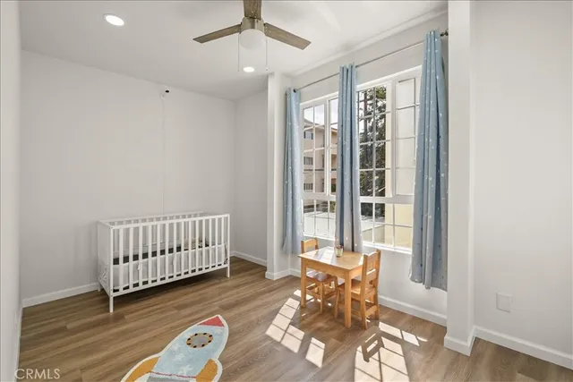 a view of a room with wooden floor and white walls