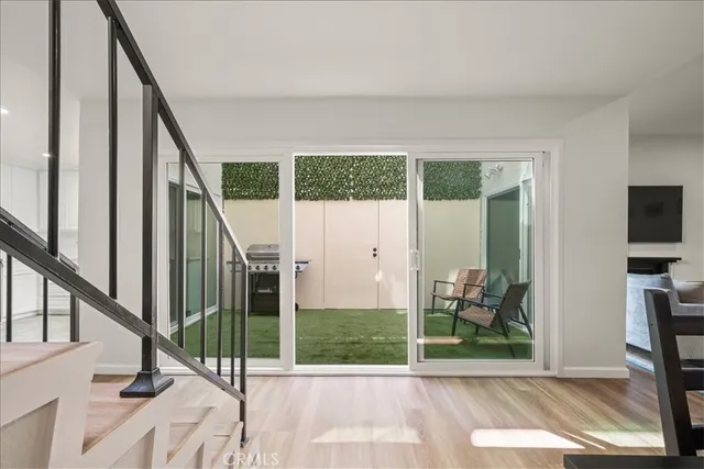 a backyard of a house with table and chairs