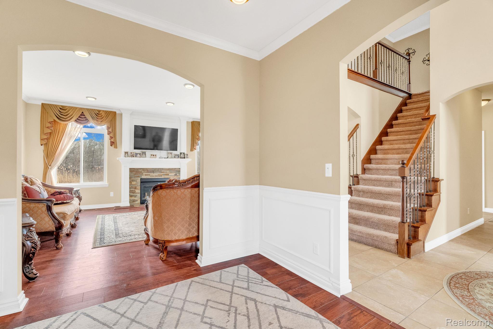 4122 Hawks Nest Road Utica, MI 48317 - Photo 19 of 74 Entrance foyer featuring ornamental molding, arched walkways, hardwood / wood-style flooring, wainscoting, and recessed lighting