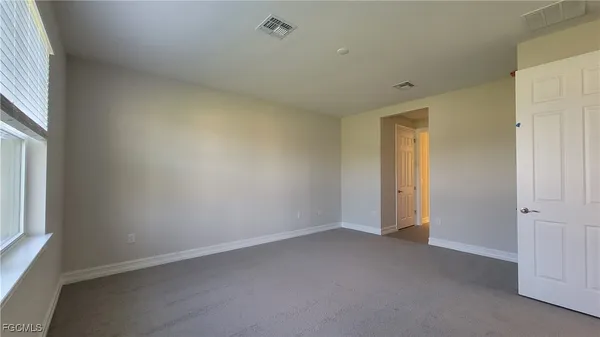 an empty room with a empty space and a window