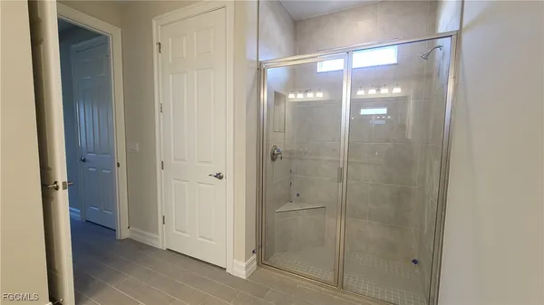 a bathroom with a glass shower door