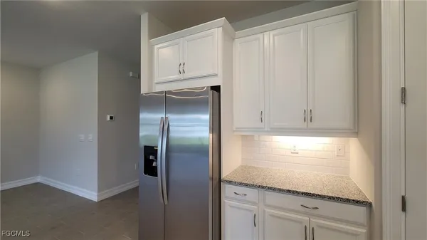 a kitchen with appliances cabinets and a refrigerator