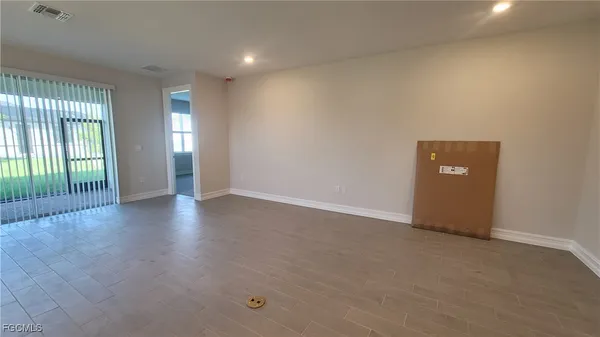 an empty room with windows and entrance