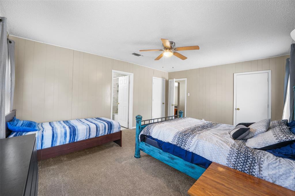 1145 Jefferson Road Paris, TX 75460 - Photo 14 of 17 a bedroom with a bed and a chandelier