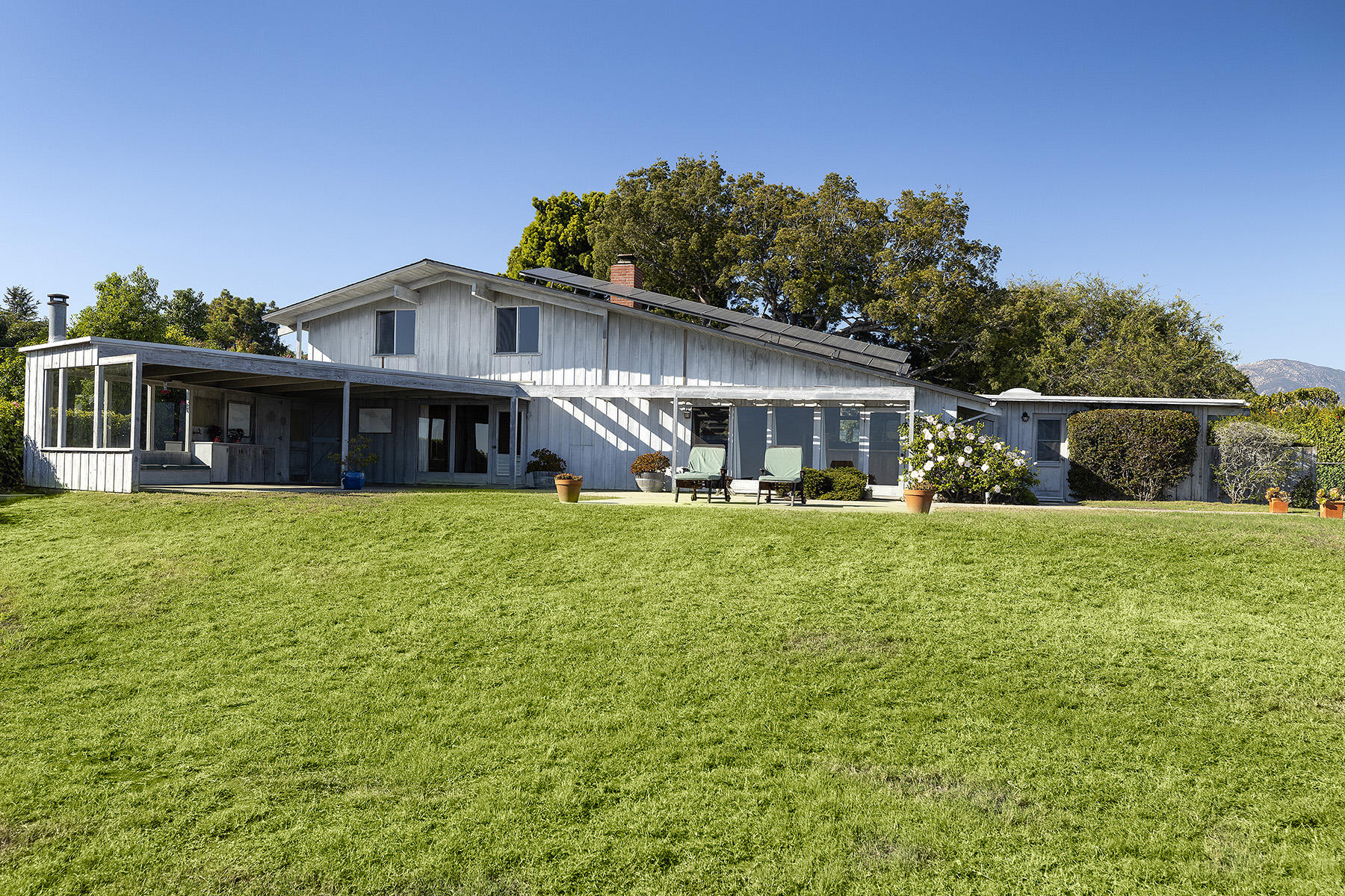 3239 Cliff Drive Santa Barbara, CA 93109 - Photo 3 of 8 a front view of a house with a yard
