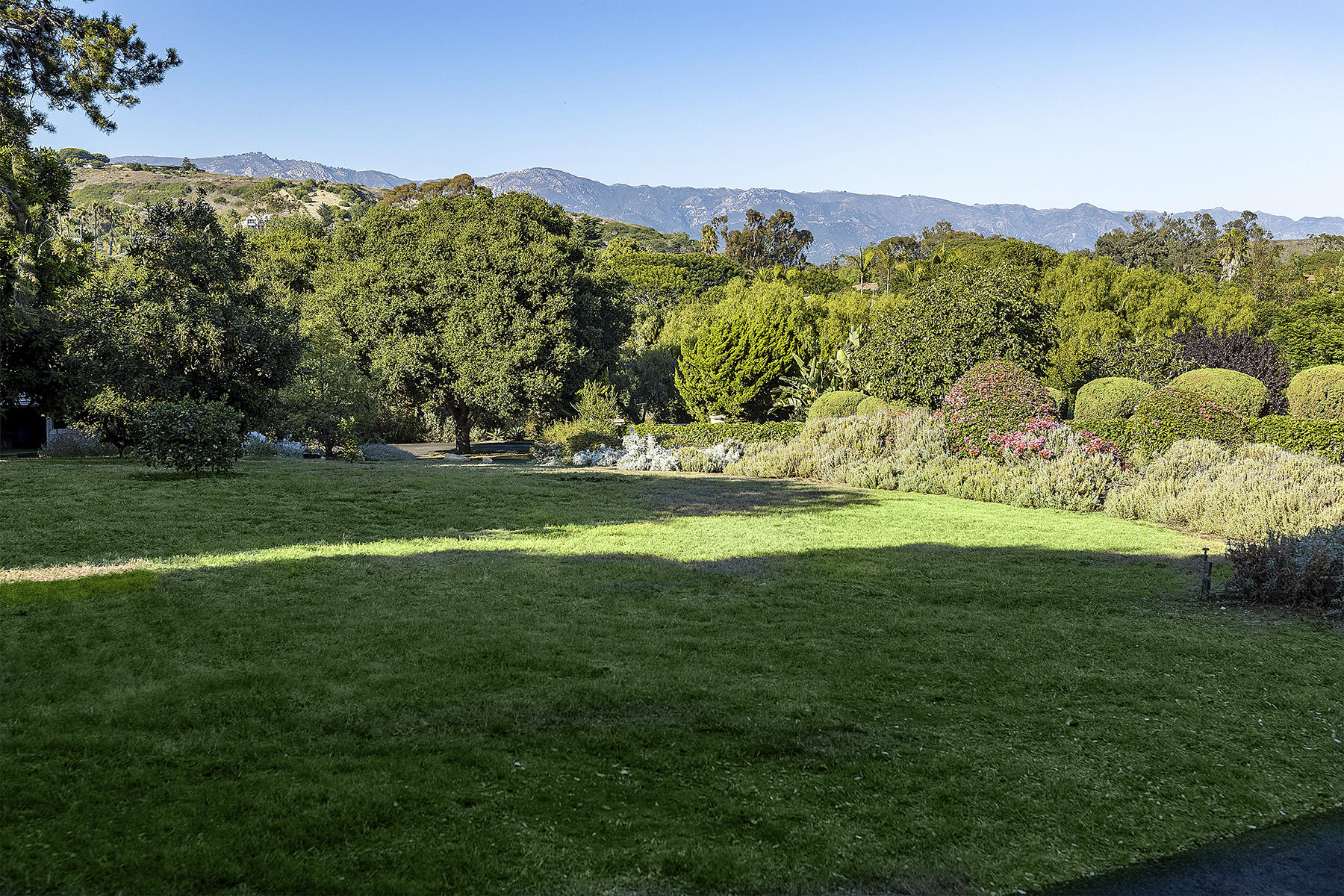 3239 Cliff Drive Santa Barbara, CA 93109 - Photo 5 of 8 a view of a lush green field with mountains in the background