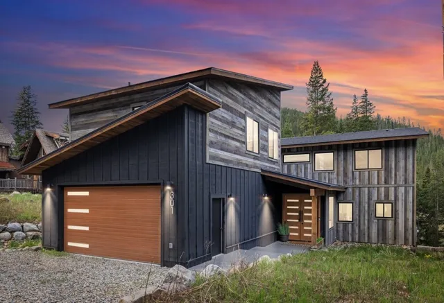 a view of a room with wooden floor and door