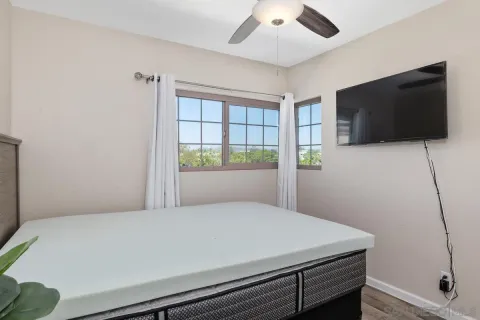 a bedroom with a bed and a flat screen tv