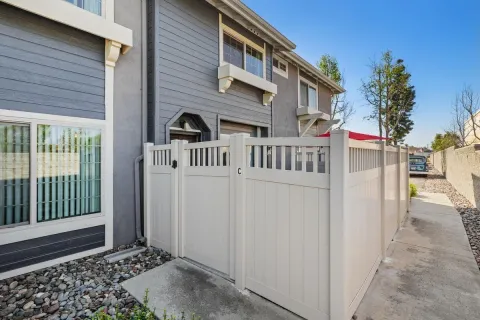 a view of a house with a small yard and a large window