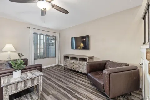 a living room with furniture a chandelier and a flat screen tv