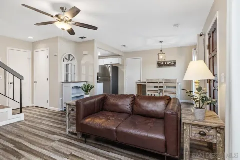 a living room with furniture and a chandelier
