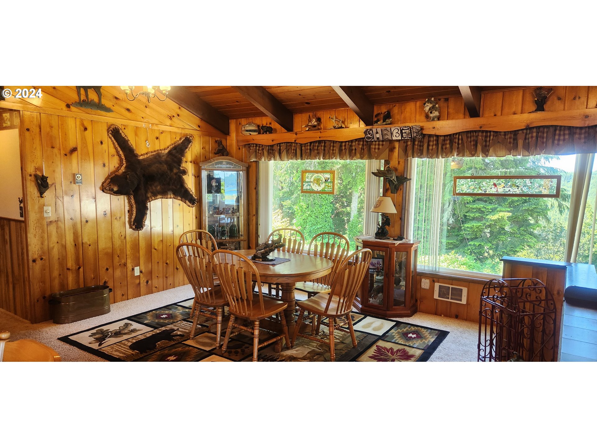 630 Crestview Drive Reedsport, OR 97467 - Photo 20 of 44 a view of a patio with table and chairs with wooden floor