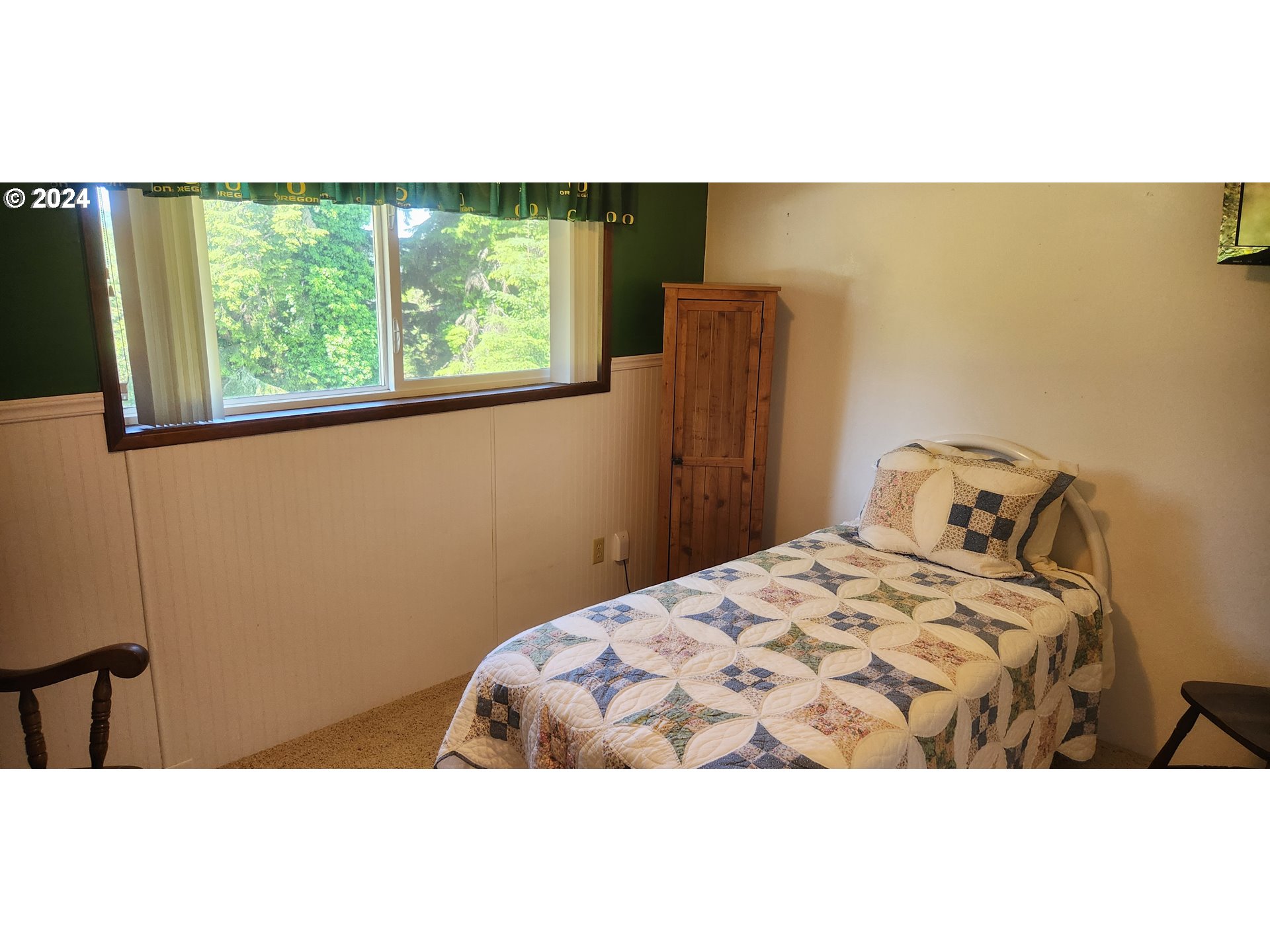 630 Crestview Drive Reedsport, OR 97467 - Photo 24 of 44 a bedroom with a bed and a window