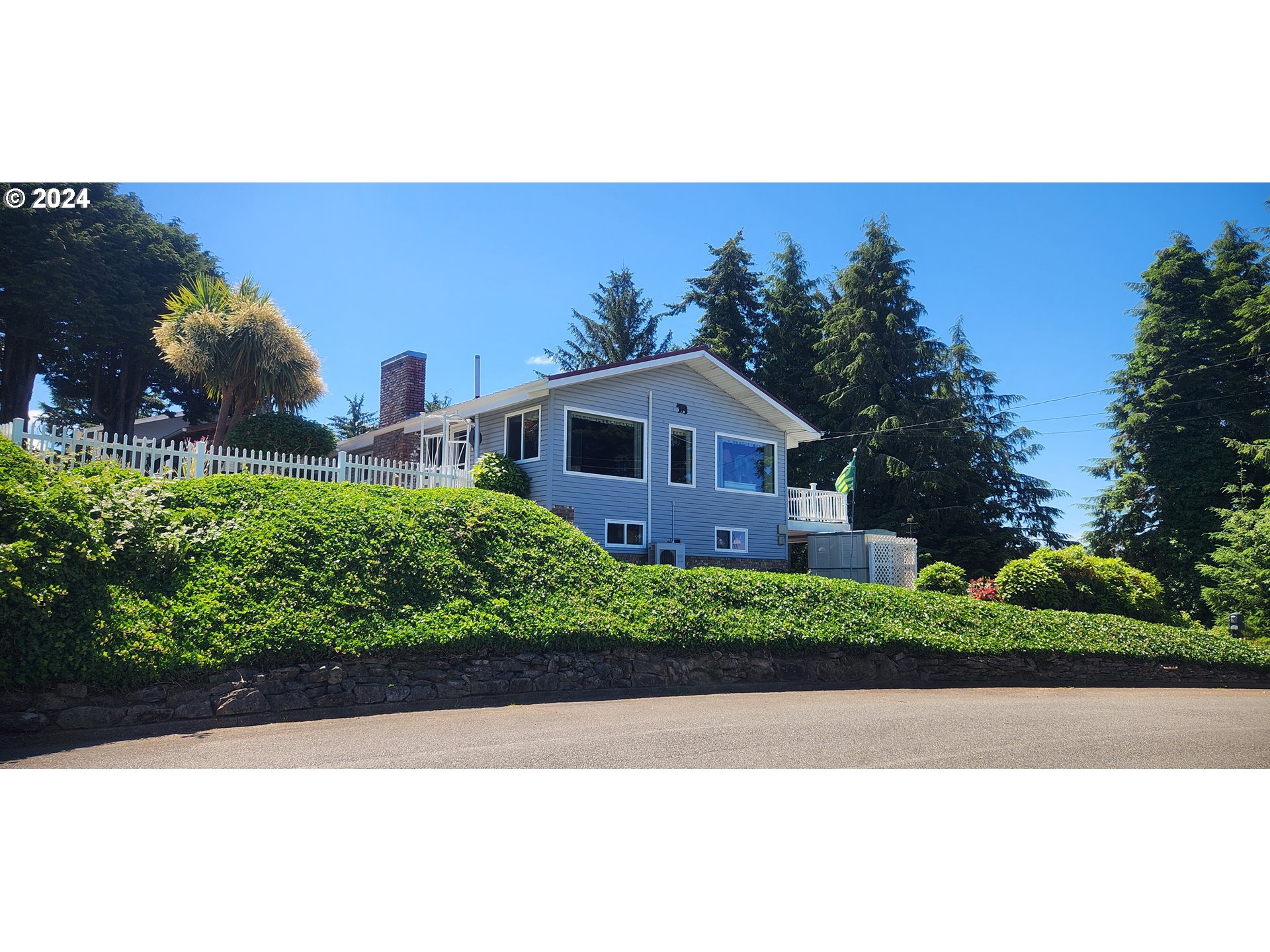 630 Crestview Drive Reedsport, OR 97467 - Photo 4 of 44 a view of a house with a yard and potted plants