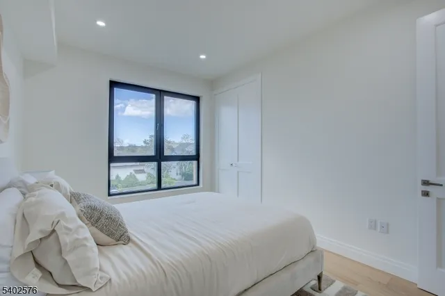 a bedroom with a large bed and a large window