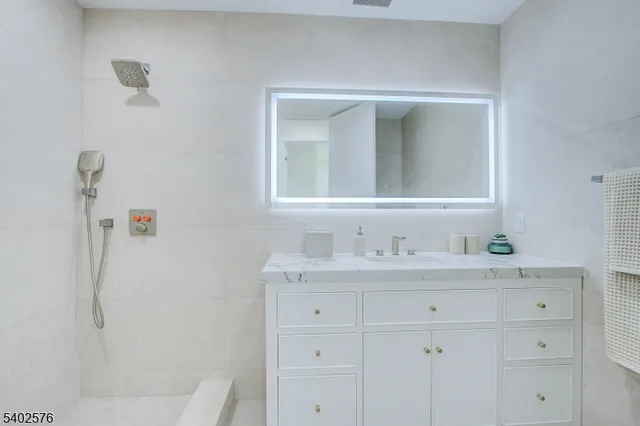 a bathroom with a sink vanity and mirror
