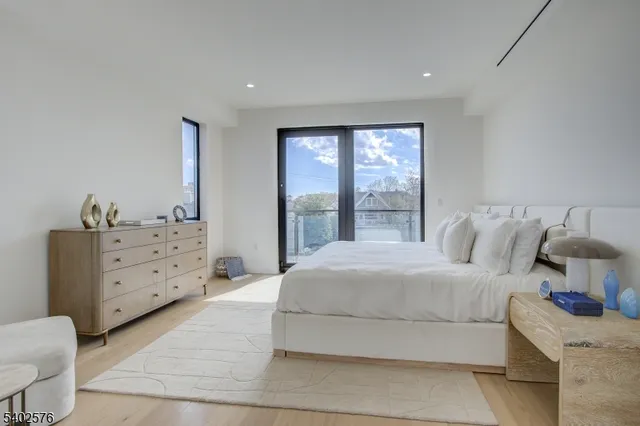 a spacious bedroom with a bed and window