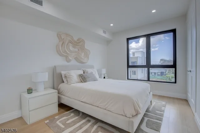 a bedroom with a large bed and a window