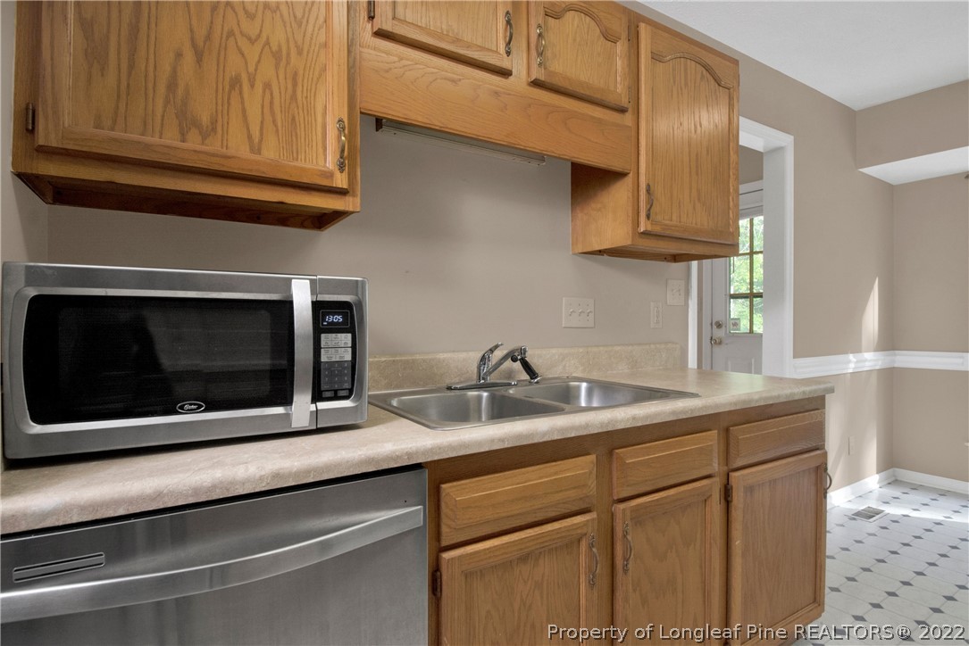 5090 Summer Ridge Road Fayetteville, NC 28303 - Photo 13 of 30 a kitchen with stainless steel appliances granite countertop a sink and a microwave