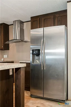a kitchen with a refrigerator and a sink
