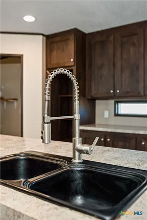 a kitchen with granite countertop a stove and a sink