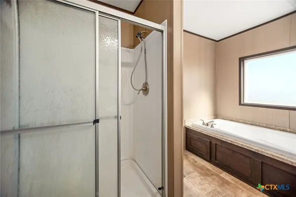 a bathroom with a shower and a sink