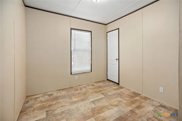 a view of an empty room with a window