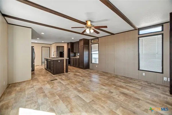 a view of a hallway with a kitchen