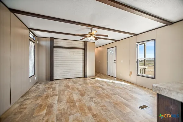 a view of an empty room with a window