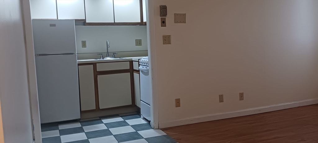 70 Southbridge Street, Unit 504 Worcester, MA 01608 - Photo 8 of 15 a room with a refrigerator and a stove