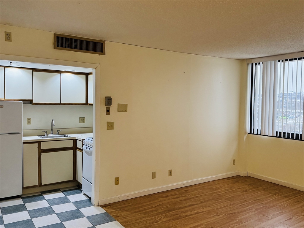 70 Southbridge Street, Unit 504 Worcester, MA 01608 - Photo 9 of 15 a view of a kitchen with wooden floor and a sink