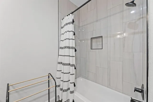 a bathroom with a bathtub and shower