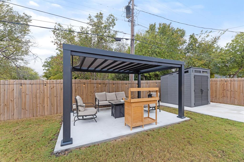 1530 East Cannon Street Fort Worth, TX 76104 - Photo 15 of 16 a view of patio with table and chairs under an umbrella with a small yard