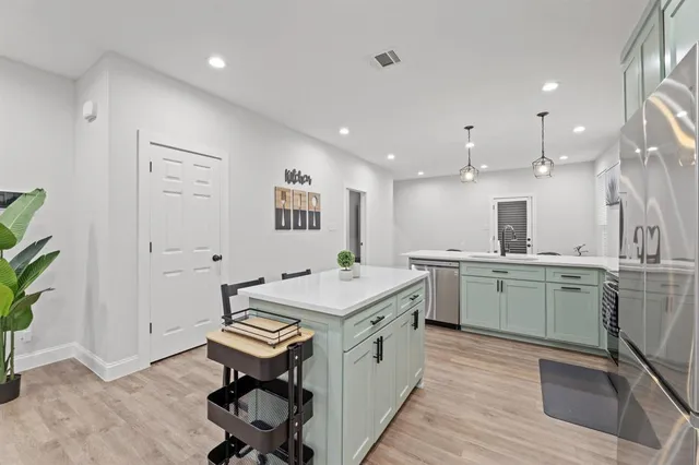 a kitchen with a sink appliances and cabinets