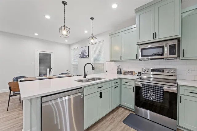 a kitchen with a sink stove and microwave
