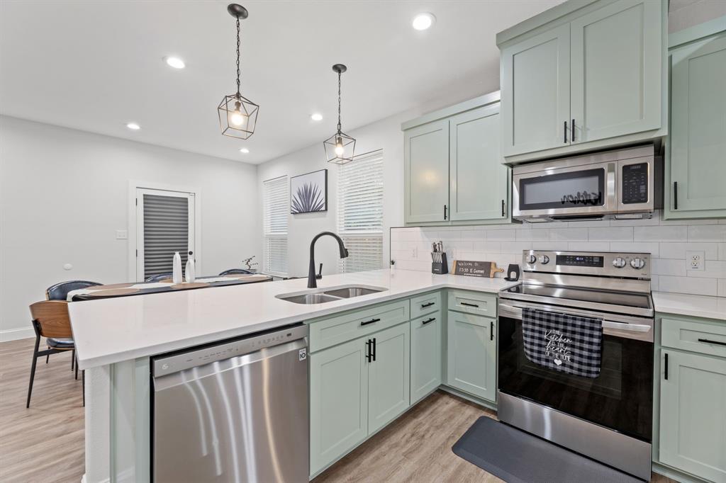 1530 East Cannon Street Fort Worth, TX 76104 - Photo 6 of 16 a kitchen with a sink stove and microwave