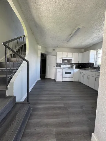a view of kitchen with sink microwave and stove