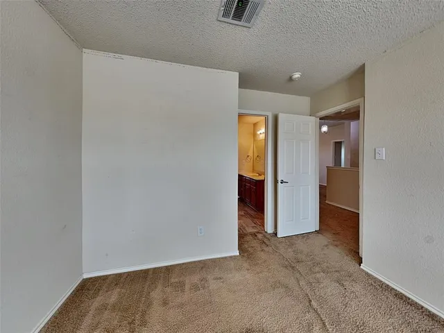 an empty room with closet and a bathroom