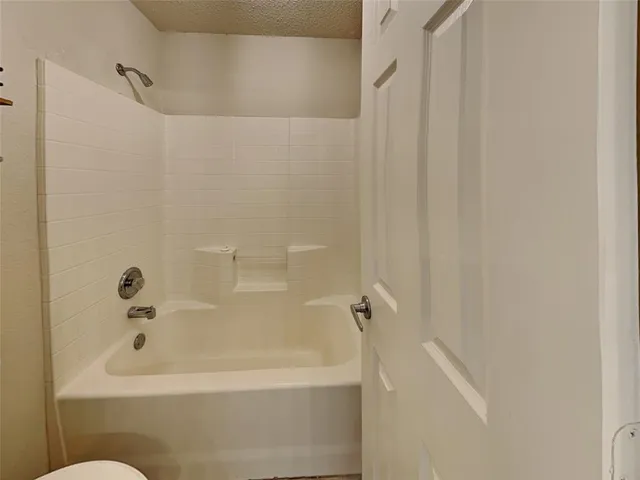 a white bath tub and shower