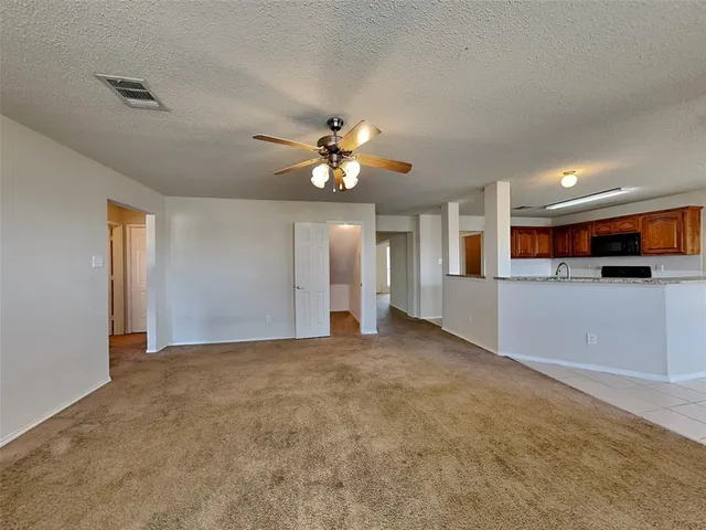 a view of a kitchen with a sink a refrigerator and a window